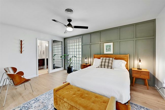 Views of another floor-to-ceiling window and the en-suite bathroom entry. | Image 18