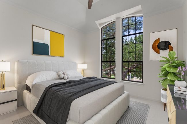 Bedroom with light colored carpet and lofted ceiling | Image 27