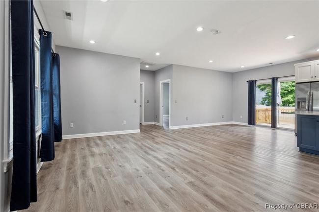 Unfurnished living room with light wood-style flooring, recessed lighting, and baseboards | Image 9