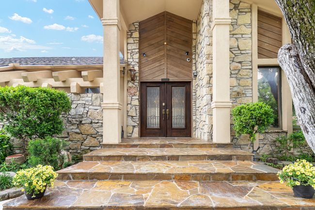 Doorway to property with french doors and stone siding | Image 8