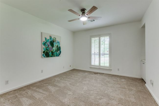 Bedroom with large sliding door closet and built in cabinet & shelving faces south and would make a wonderful office space. | Image 14