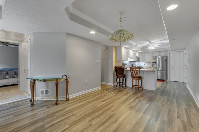 This is the dining area. Seller has removed dining table as they are preparing to move. What a great space, leads dircetly to the updated kitchen. You can see the 3 bedroom from this photo which is located just inside the entry door to the left. | Image 5
