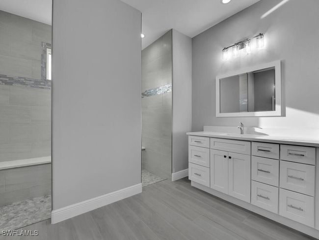 Full bath featuring a walk in shower, vanity, wood finished floors, and recessed lighting | Image 21