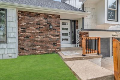 Doorway to property with a lawn | Image 3