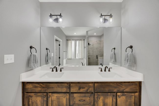 Full bathroom featuring a sink, a stall shower, and double vanity | Image 22