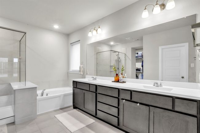 Full bathroom featuring a sink, a garden tub, double vanity, and a shower stall | Image 16
