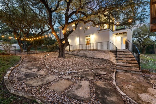 paved walking paths leading to the lower level of the home and to the covered pavilion. | Image 4