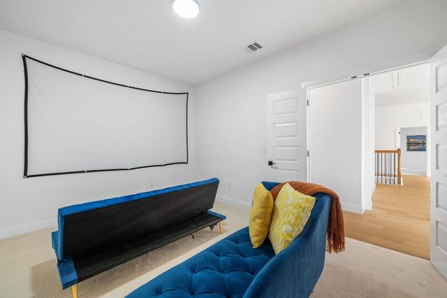 The luxurious media room is designed for ultimate relaxation and entertainment, offering a spacious and inviting atmosphere to enjoy movie nights, game days, or streaming marathons with family and friends. Thoughtfully crafted with premium finishes, optimal acoustics, and ample seating, this space delivers a true cinematic experience in the comfort of home. | Image 29