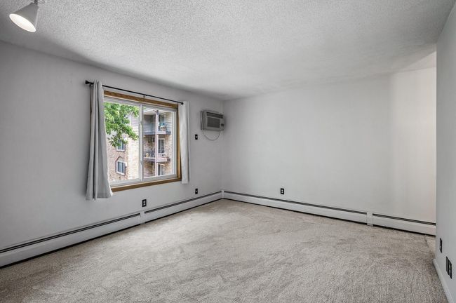 The primary bedroom is spacious with fresh neutral paint, new carpet, and abundant natural light. | Image 13