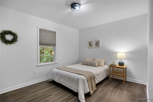 Bedroom with dark wood-style flooring and baseboards | Image 16