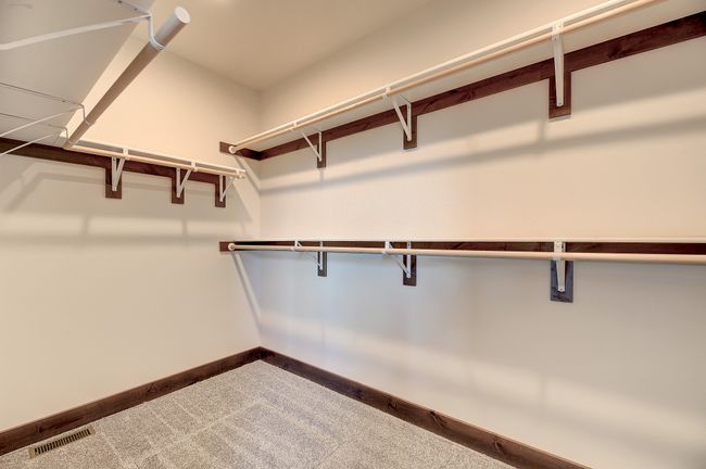 Walk in closet featuring carpet floors | Image 9