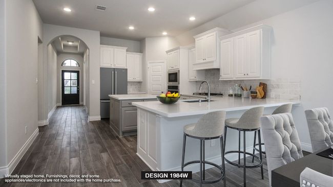 Kitchen with stainless steel appliances, arched walkways, a peninsula, dark wood-type flooring, and white cabinetry | Image 6