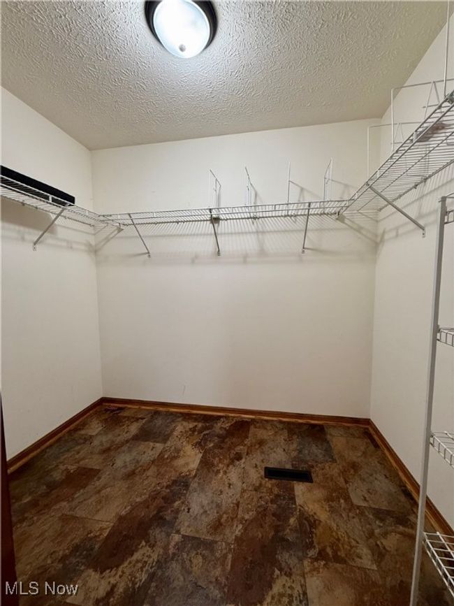 Walk in closet with stone finish flooring | Image 21