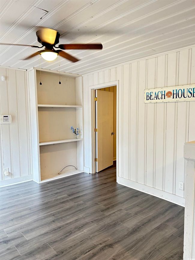 Spare room featuring a ceiling fan and wood finished floors | Image 4