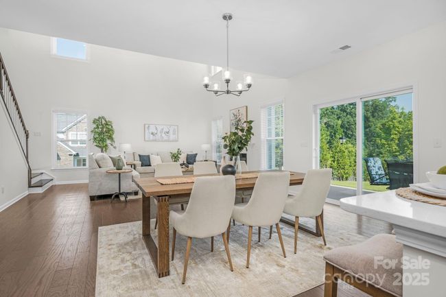 Dining area between the kitchen and great room. Plenty of room for entertaining. Note the satin nickel fixtures throughout the interior | Image 9