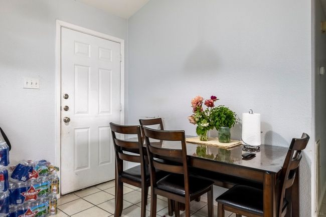 Dining space featuring light tile patterned floors | Image 7