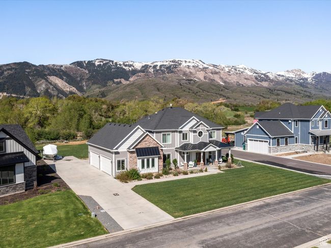 Craftsman inspired home with stone siding, concrete driveway, a standing seam roof, and a mountain view | Image 48