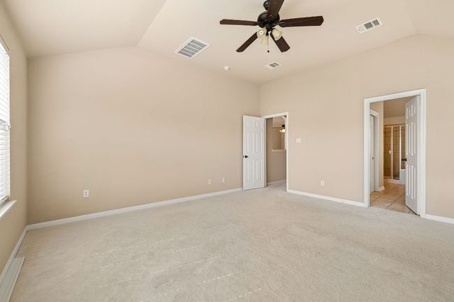 Primary suite offers high ceilings with ceiling fan | Image 19