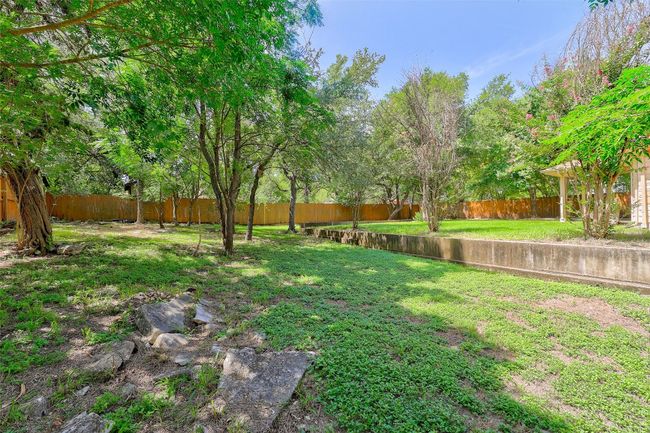 View of back yard retaining wall and beautiful trees | Image 33