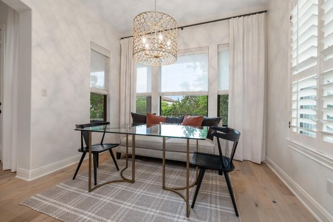 Breakfast room featuring a chandelier, wood finished floors, and baseboards | Image 12