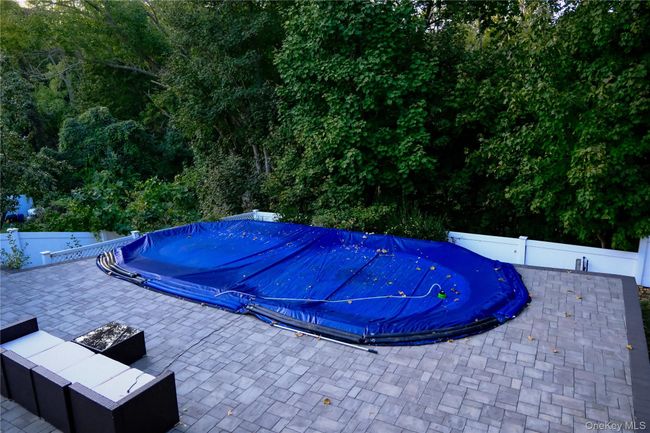 View of pool with a fenced backyard and a patio | Image 8