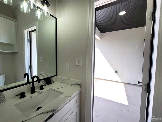 Bathroom featuring vanity, concrete flooring, and toilet | Image 22