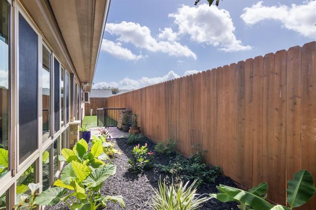 Gorgeous landscaping and private dog run with a gate. | Image 38