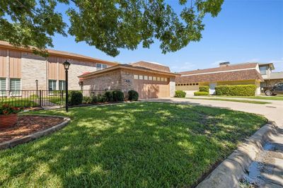 View of front of home with a front yard and a garage | Image 1