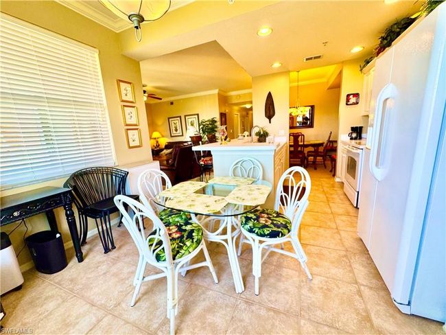 Dining space featuring visible vents, recessed lighting, crown molding, light tile patterned floors, and ceiling fan | Image 9