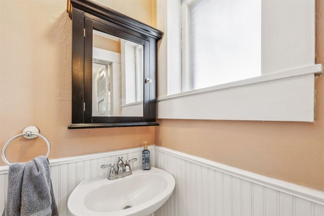 Bathroom featuring wainscoting and a decorative wall | Image 19