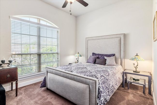 Carpeted bedroom featuring a ceiling fan and baseboards | Image 21