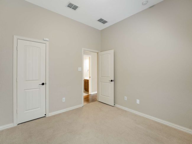 Unfurnished bedroom with light colored carpet and baseboards | Image 30