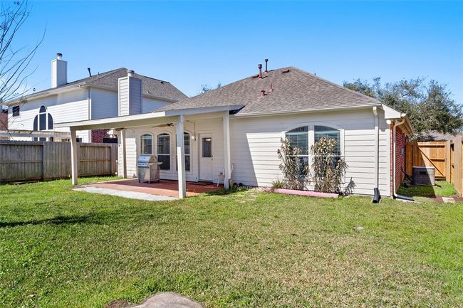 The large back covered patio. The BBQ grill is not included with the sale. | Image 20