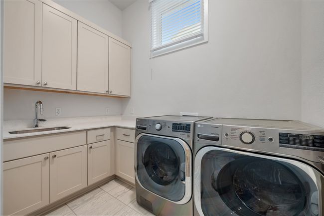 Laundry room feature storage, sink, workspace, and wall mounted collapsable drying rack. | Image 28