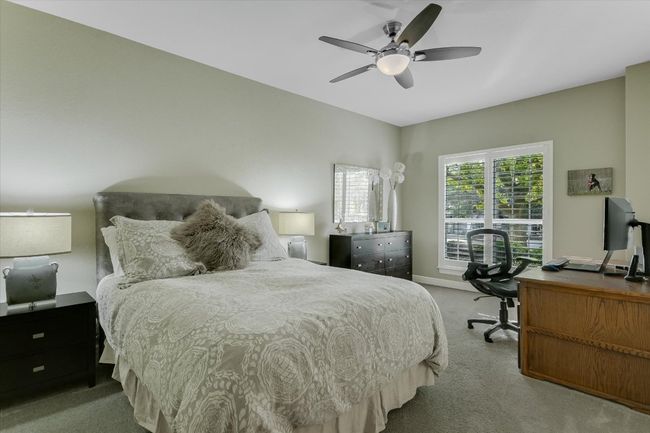 Bedroom with a ceiling fan, carpet floors, and baseboards | Image 17