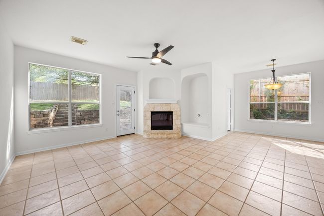 The family room has a corner fireplace with a gas starter. Works with real wood or gas logs. | Image 7