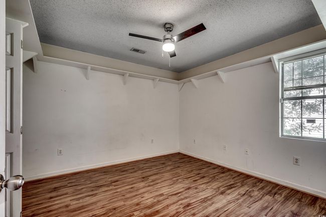 Unfurnished room featuring a textured ceiling, wood finished floors, and a ceiling fan | Image 29