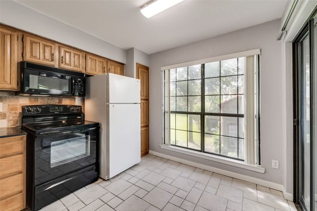 Kitchen featuring black appliances and dark countertops | Image 6