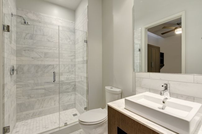 Full bathroom featuring toilet, a stall shower, a ceiling fan, and vanity | Image 16