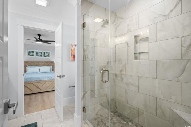 Full bath featuring a shower stall, ensuite bath, a ceiling fan, and light tile patterned floors | Image 17