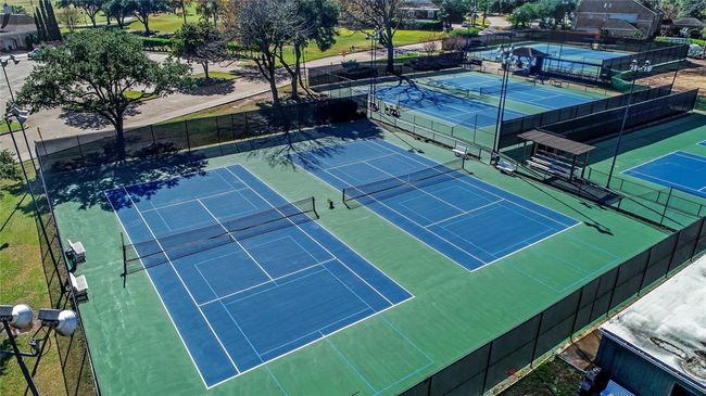 The tennis court at Sugar Creek is a beautifully maintained facility, perfect for both casual games and competitive matches. Surrounded by lush greenery, it provides a serene environment for residents to enjoy their game. The court's smooth surface and well-placed fencing offer a great playing experience for players of all skill levels, whether you're practicing your serve or engaging in a friendly match with friends or neighbors. | Image 48
