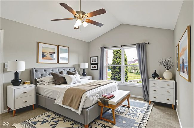 carpeted primary bedroom with vaulted ceiling, ceiling fan, water view and massive walk in closet | Image 20