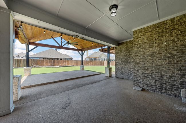Fenced backyard featuring a ceiling fan and a patio | Image 31