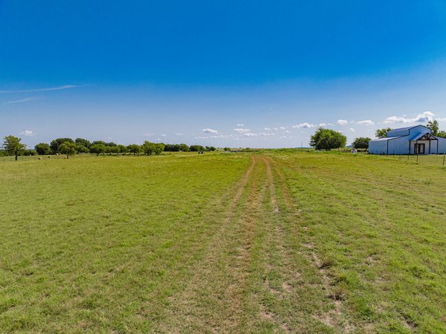 View of green lawn with a view of countryside. | Image 15