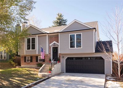 Classic brick + neutral front facade with new roof, garage door + driveway | Image 1