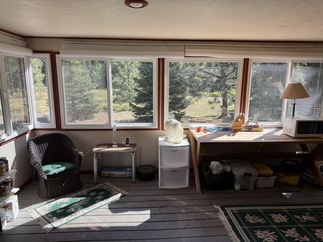 Sunroom with plenty of natural light, wood-type flooring, and a wooden deck | Image 19