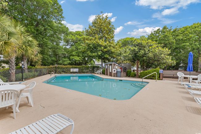 Community pool with a patio area and fence | Image 35