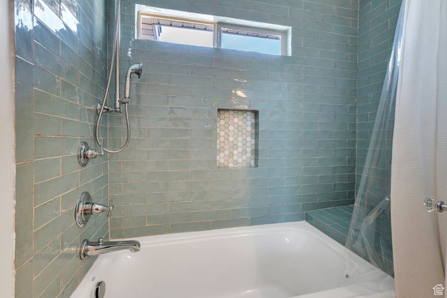 Full bathroom featuring shower / bath combination with curtain | Image 30