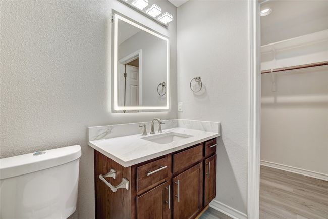 Primary bathroom with lighted mirror a spacious walk-in closet | Image 20