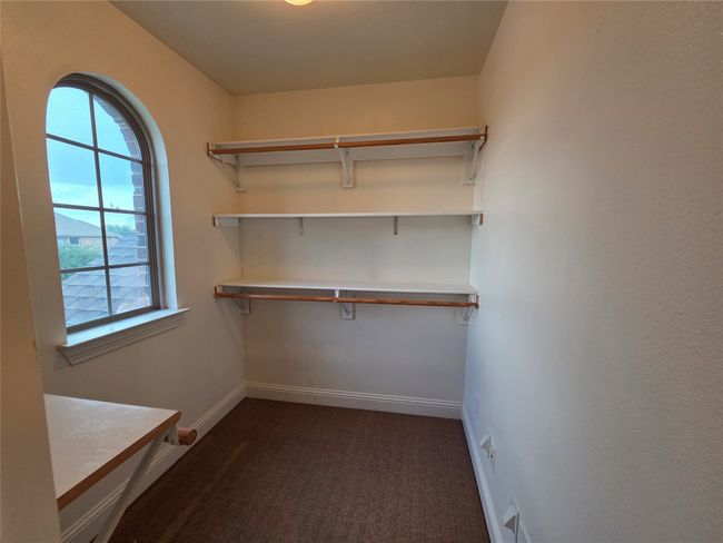 Walk in closet with dark colored carpet | Image 23